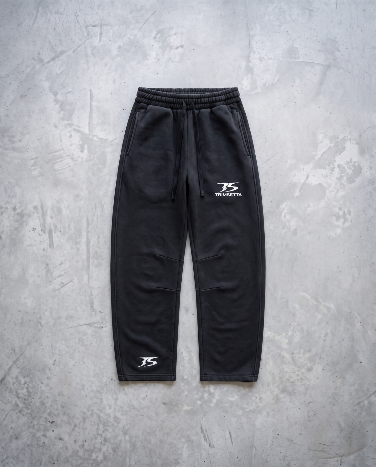Blackout Sweatpants – flat lay on concrete