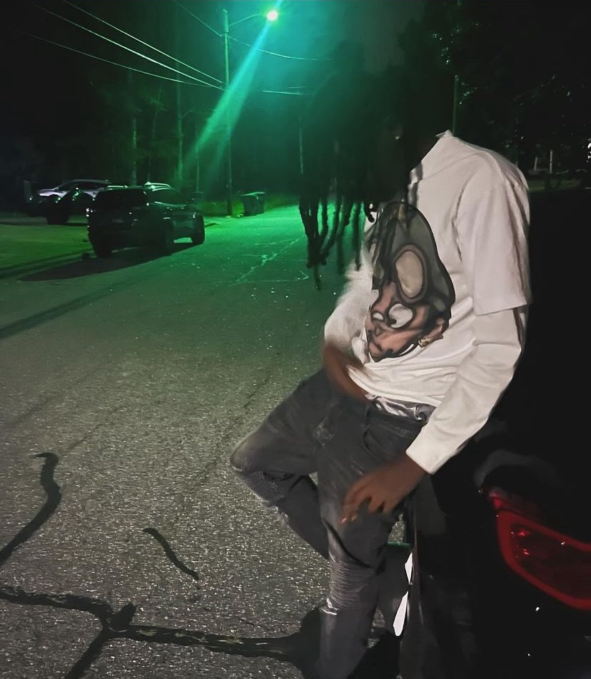 Customer in the Vertidíem Fight for Freedom tee layered over a long sleeve at night